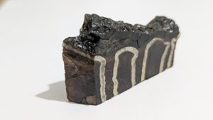 Cut surface beside the natural one - the unworked tooth surface shows along the top